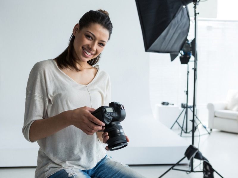 Photographer in a studio with lighting and camera - Ideas on how to be creative with your real estate video content - Image