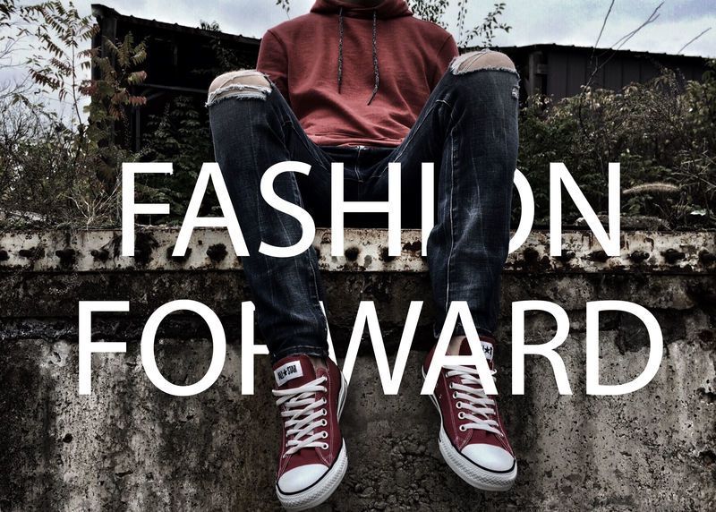 A young person in a red hoodie, torn jeans, and red sneakers sits on a concrete fence - Mixing real objects with typography is a modern design style - Image