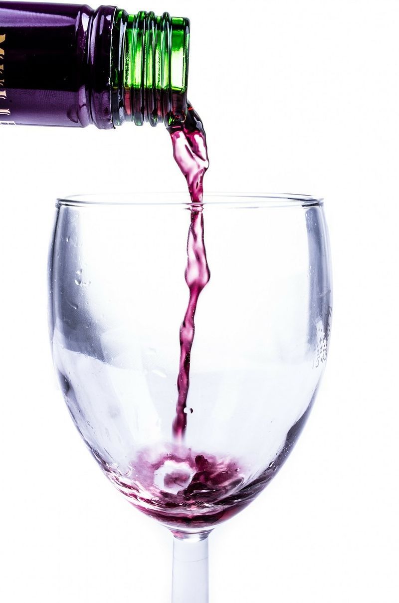 Wine is poured into a glass from a bottle - Celebrate your birthday with a wine tasting - Image