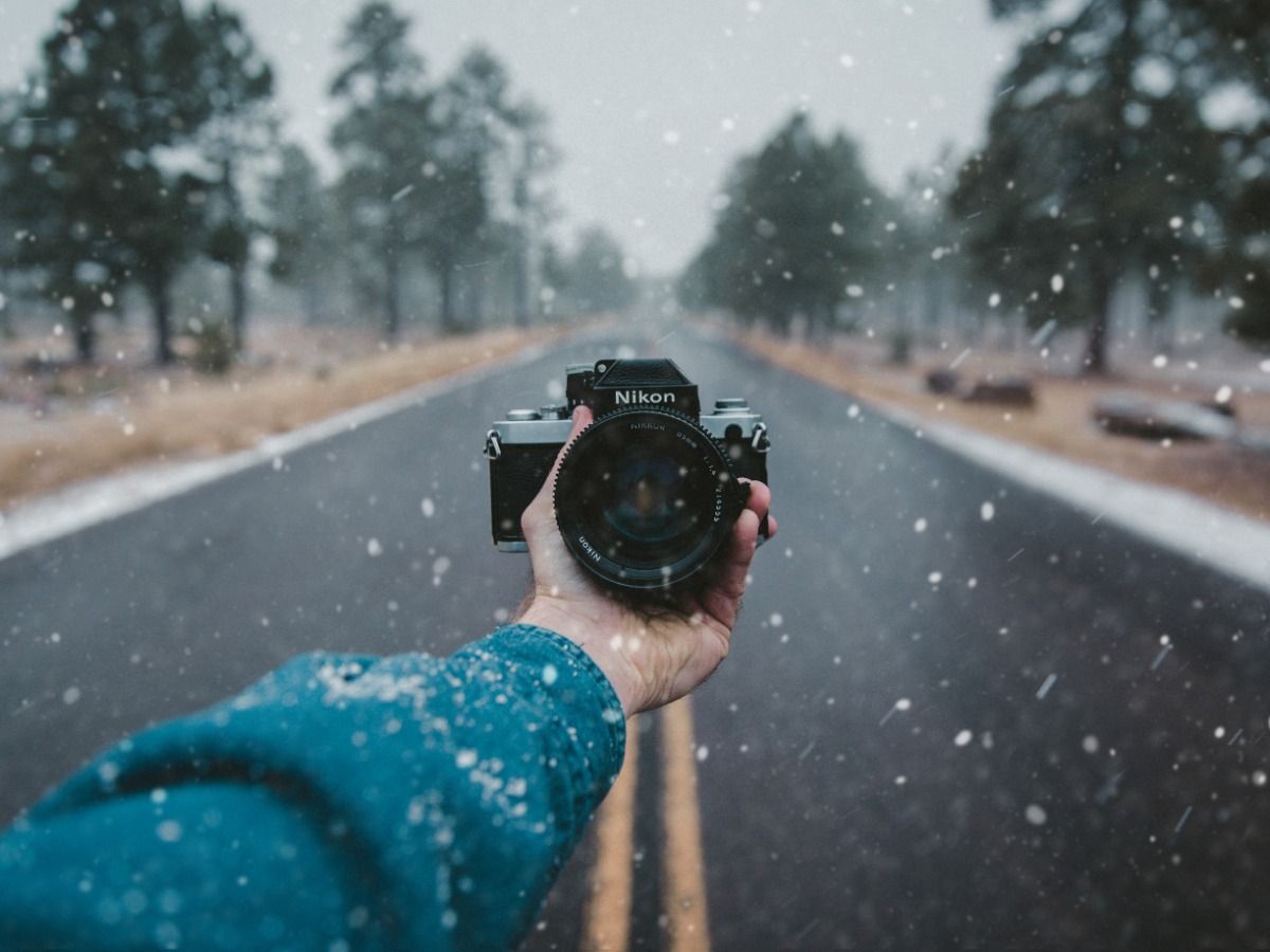 A man takes a selfie with a Nikon camera while it snows - Download and experiment with free images - Image