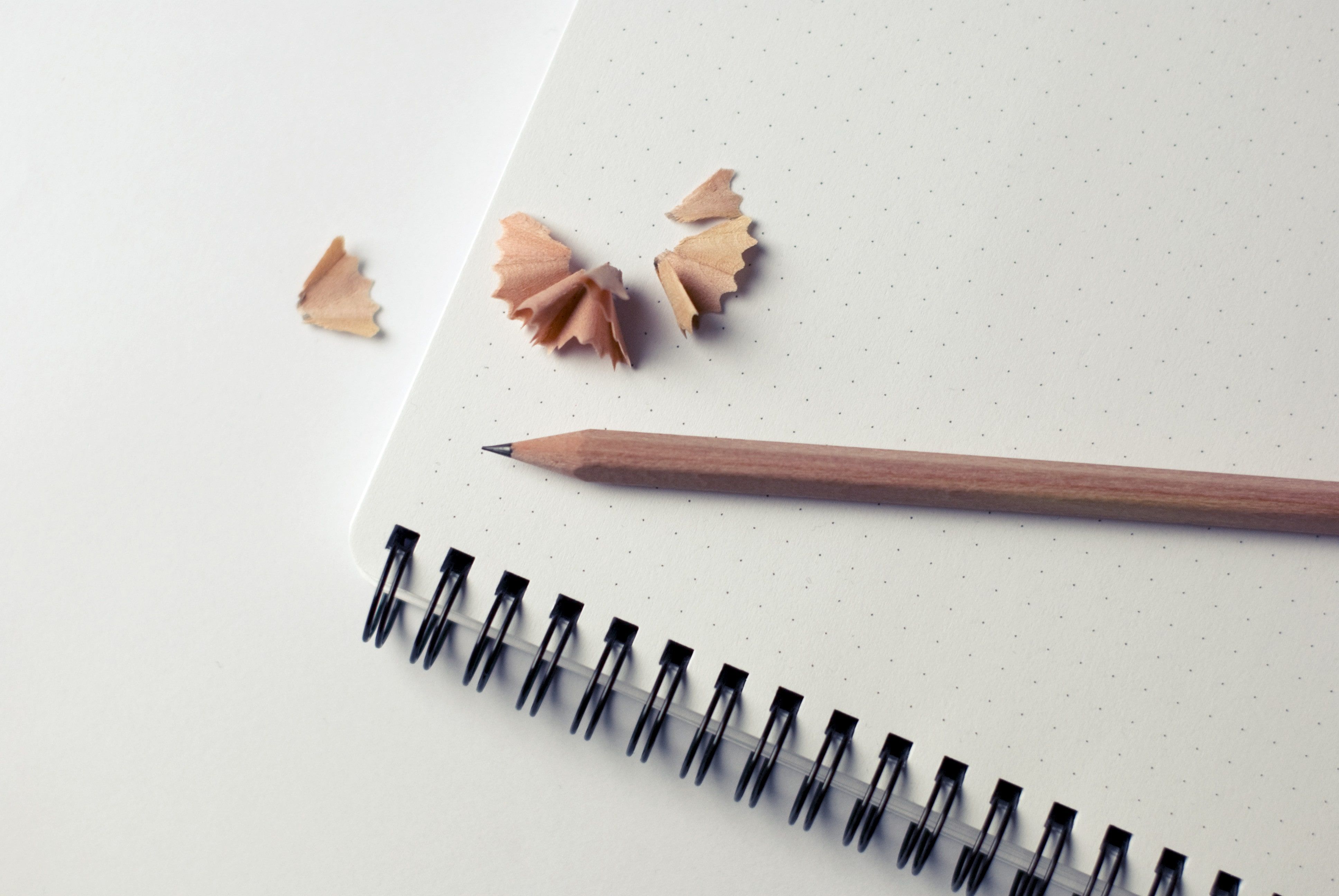 Pencil with pencil sharpening's on notebook - Where to place your branding - Image