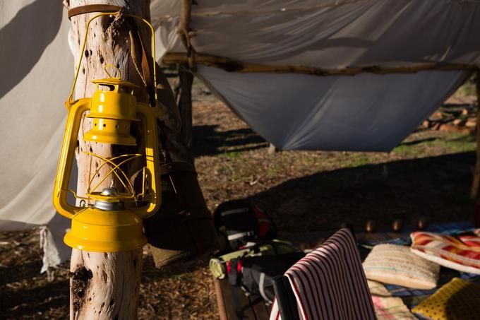 A yellow camp lantern hangs on a tree - 80 Creative and inspiring engagement party ideas - Image
