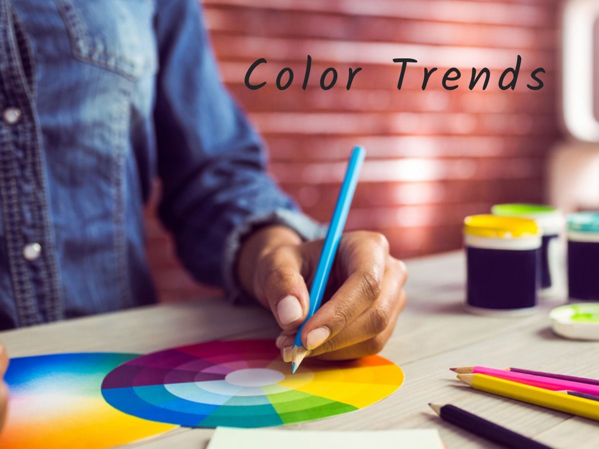 Person with blue pencil and colour wheel - The biggest trends in graphic design - Image