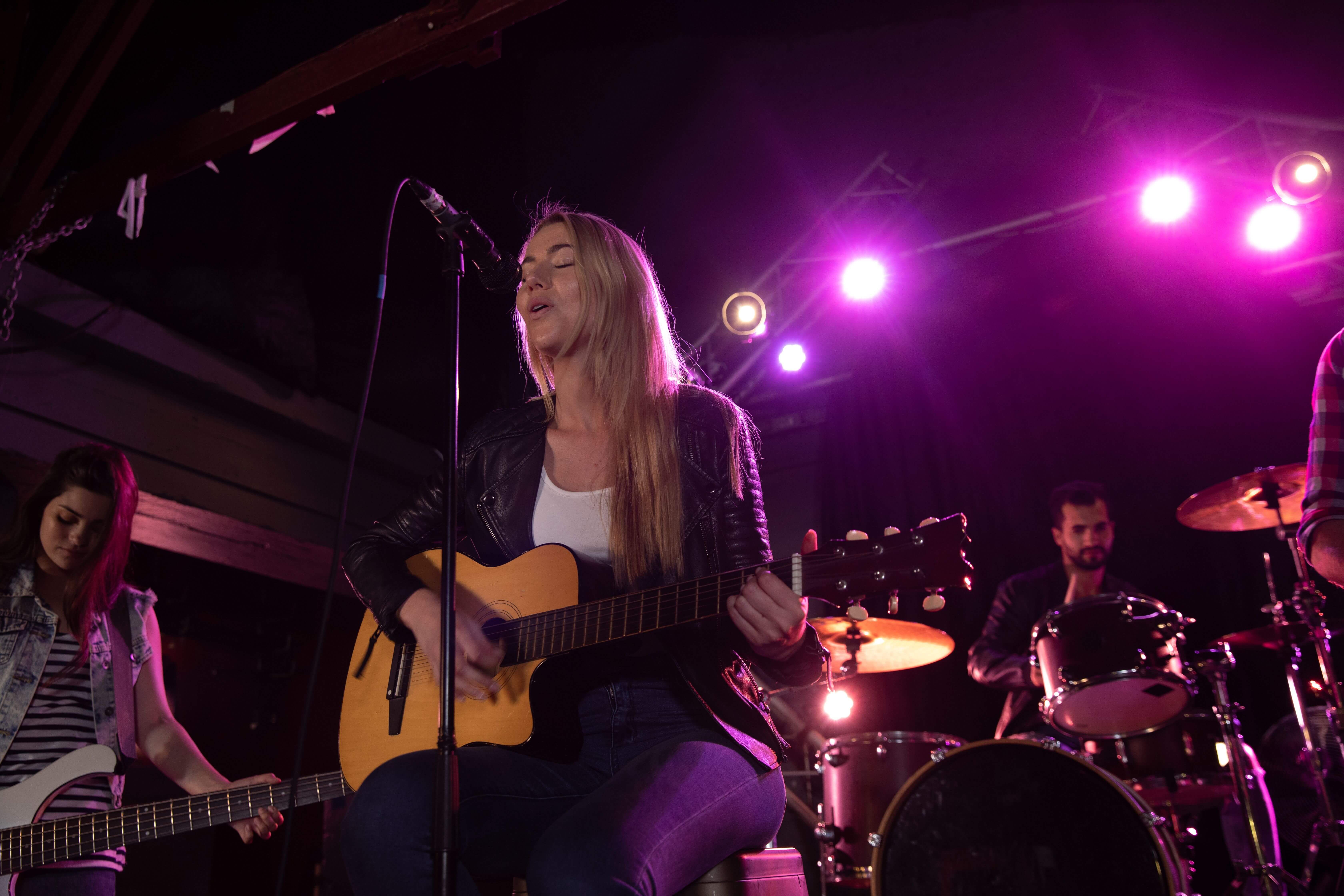 Female singer performs at acoustic set - 7 top marketing strategies for musicians - Image
