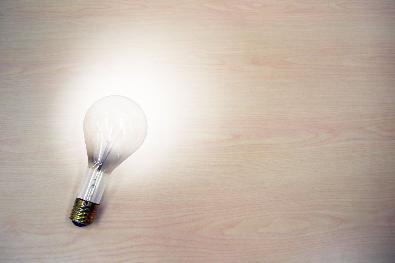 Light bulb on table Providing the solution to the prospect in your sales strategy - Twenty-eight helpful sales strategy ideas for boosting your business growth - Image