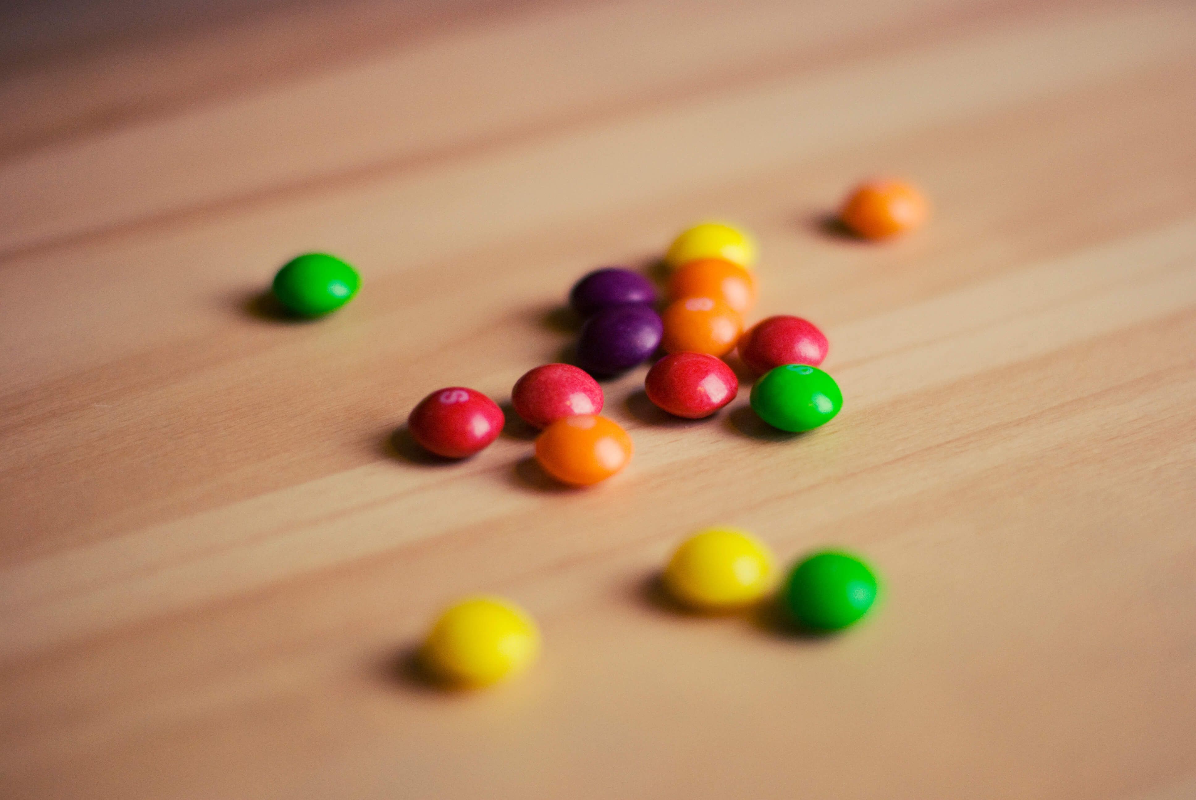 Skittles on a table - How to design clever student council posters, 30 ideas to boost your creativity - Image