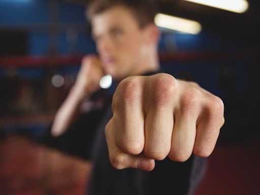 Man holding knuckles towards camera preparing for student council debate - How to design clever student council posters, 30 ideas to boost your creativity - Image