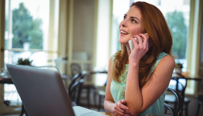 Woman chatting on phone relationship marketing - The ultimate guide to relationship marketing - Image