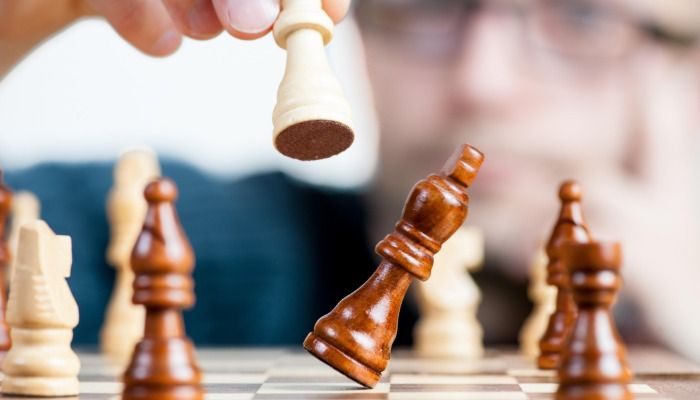Chess piece being knocked over on board - The ultimate guide to relationship marketing - Image