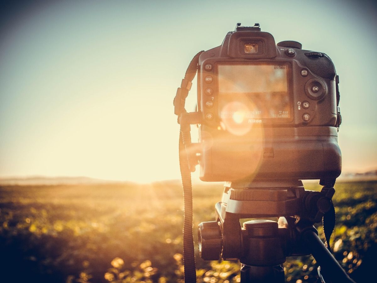 Photo of a camera on a tripod - Essential video marketing tips for beginners - Image