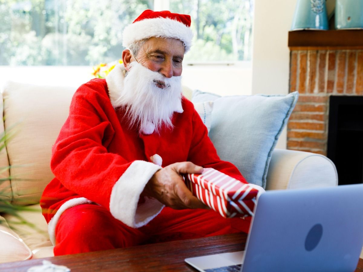 Image of Santa giving a gift via laptop - Essential video marketing tips for beginners - Image