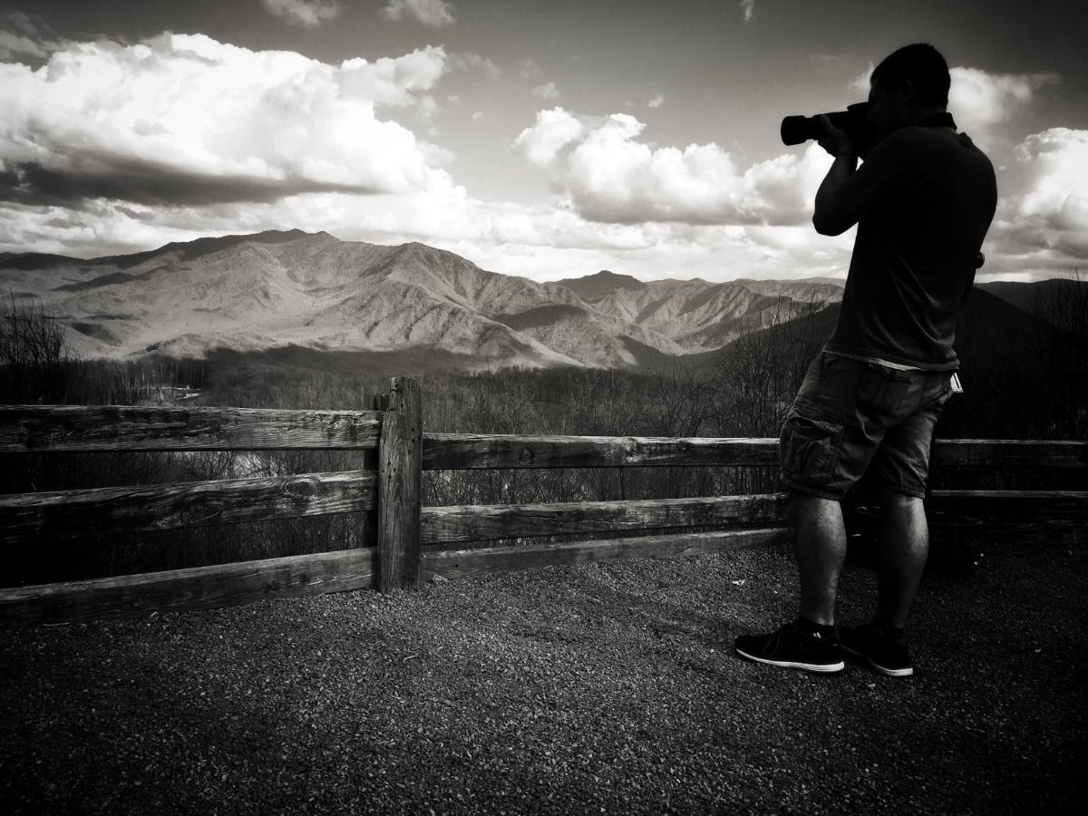 Black and white image of a photographer - Essential video marketing tips for beginners - Image